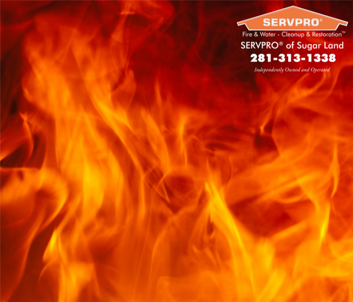 Flames cover the entire photo.  SERVPRO of Sugar Land logo and company information on the far top right hand corner. 